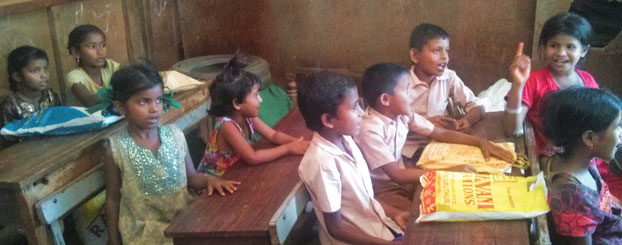 Assamese children reciting rhymes in school.
