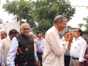 RI President K R Ravindran and RID Manoj Desai being welcomed at the Gejha village school.