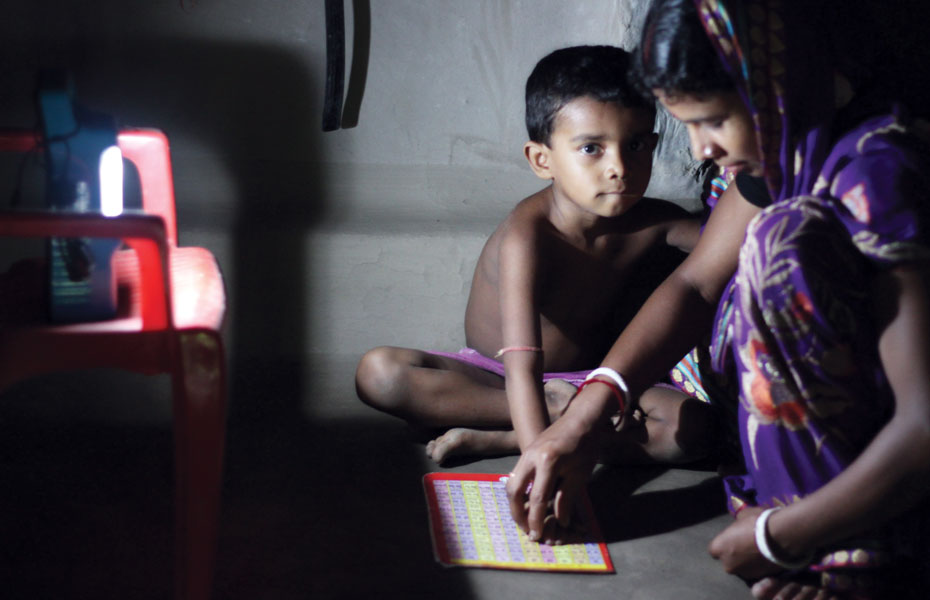 Solar lamp helps him to study at night.