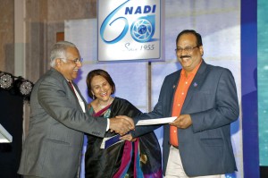 Marlene Kamdar handing over a DD of $25,000 for TRF to RI Director Manoj Desai. Also present DG D 3230, C R Raju.