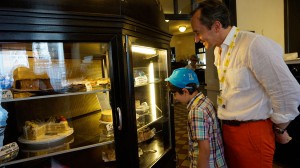 A little boy struggles to decide on his pastry at Café Central.