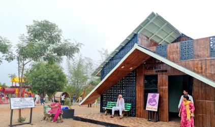 A Rotarian builds a house from plastic waste