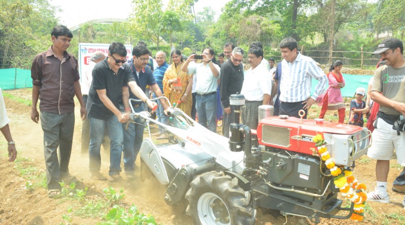 Rotarians operate the power tiller donated to the Sansthan.