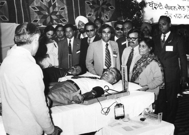 Rtn Brijmohan Lall Munjal donating blood at a Rotary Conference in 1973. There are people, though not very often, who come to the world with divine blessings and make their own destiny, overcoming the challenges of humble beginnings and life’s hurdles. In the process they create history. Such a person is known as a Yug Purush, or a person of an era. And when they depart they leave an indelible mark on posterity to remember.   Brijmohan Lall Munjal, Chairman Emiretus of Hero MotoCorp, was one such person born in 1923 in Kamalia, now in Pakistan. When he passed away on November 1 at the age of 92, an era passed with him. The era that saw the Partition of the country with immense human tragedies, but also the emergence of a new India with hope, freedom and opportunities. In this new era, achievements in science radically changed lives and opened new vistas for better quality of life. In this period, mobility patterns changed, and bicycles and later motorised two wheelers, became popular and remain even today the most commonly used vehicles. Brijmohanji became a part of this upswing. After Partition he settled in Ludhiana, Punjab, first selling bicycle parts door-to-door and then manufacturing them. The whole family became a part of the business and soon Hero was born, manufacturing bicycles, competing with even world-class brands. Under his leadership Hero Cycles became the world’s largest bicycle manufacturer. But he had a larger vision and simultaneously went into manufacturing motorcycles and scooters. Today the group is the biggest in the two-wheeler segment. Spirituality, compassion But I don’t want to talk about how great Brijmohanji was as entrepreneur extraordinaire, which he indeed was, but to share my thoughts about him as a man. Each one of us faces a choice as we move on in life. This journey challenges us to find a vision and then to make that vision a reality. But only very few can convert that vision into action. There are no limits on how you envision life. Most have limitations but he was one who extended his limits further and further. This made him different from all others. He was not only beyond self- consciousness but also capable of shaping his own life and lives of those who came in touch with him. This he did through his inner potential of spirituality blended with compassion and action. It was my privilege to know ­Brijmohanji as we walked along the Rotary path. This co-travel converted first into close friendship and then a family-like relationship. I got to know him around 1969–70 and then saw him in action in Rotary during the District Conference in Ludhiana, of which he was the chairman. I recollect well how the enormous pandal built to accommodate over 600–700 people got blown away in a thunderstorm the previous day and Brijmohanji led the team to make alternate arrangements to organise one of the most memorable conferences I’ve ever attended. That showed the capacity of the man. As we worked together in Rotary, we came close. In 1973, he became a candidate for governorship of the Rotary district encompassing the whole of Punjab, Haryana, Himachal Pradesh, J?&?K, Delhi and a substantial part of Uttar Pradesh. That year Rtn R?K Beri got elected. However, Brijmohanji’s love and work for Rotary never ceased or diminished. Ultimately he became the Governor of the bifurcated District 3090 for 1977–78. It was my privilege to handover the governorship to him after completion of my term. I could not have found a better successor to lift Rotary in the District and the country to a higher echelon. An example in service Though busy in his business and profession, he became an example of how if you have the will to extend yourself in Service above Self, you can find time both for your profession and service. He contributed his time and energies generously to Rotary, was involved in his Club and District affairs and participated in Zone Institutes. His humility and belief in social service became his trademark in human interactions. How can I forget his readiness to donate blood at the blood donation camp I had organised at the Chandigarh Conference? Whenever a project needed monetary support, he’d do his utmost for its success. When I was nominated as RI President in 1989, I was asked who I’d like to formally propose my name at the Portland Convention in 1990, a tradition then. Usha and I spontaneously thought of Brijmohanji. He immediately agreed and with his wife travelled to Portland to propose my name amidst thunderous applause. As I embraced him after my acceptance speech, he whispered in my ear: “Raja, from now on, I will devote more time in serving humanity and will be at your disposal all the time.” He then gradually retired from active business, handing it over to his sons and devoted more time to spiritual and service pursuits. And, along with my family members, he too attended in 1991 the Mexico City Convention. But tragedy struck him soon after, when he lost his eldest son Raman. He confided to me that his utmost concern was to look after his daughter-in-law Renu, and he plunged back into day-to-day business, and encouraged Renu to attend office, so she did not feel helpless without her husband. That was Brijmohanji. Man of values An impregnable set of values were his life’s philosophy. In Ludhiana, I’d always stay with him, and once asked him about his rather small bedroom, and wondered why he didn’t shift to a bigger house. He replied: “Raja, only when all my brothers and other family members will be able to live in separate houses with the same standards, only then I will think of making a change.” This was a great statement from a man who did not think of himself alone, but his entire family. When I asked him the secret of his overtaking so many of his competitors, he said he and his family had a personal relationship with each dealer or distributor, and one of the family members would always attend an occasion of joy or sorrow in any of their homes. He knew most of the dealers and distributors by name. This was his way of dealing with people. At no time his office was out of bounds for any Rotarian. He or she would have to just ask for an appointment and would get it. He would go out of his way to accommodate any request of help from me. We may have started together but he rose to ­Himalayan heights in business and industry and yet his affection for me was unfettered. He would call me sometimes “Sabooji” or “Raja” but his and Bhabiji’s thoughtfulness and kindness to Usha and I were boundless. I cannot forget how he came by a chartered flight to attend my granddaughter Satvika’s wedding, and most unusually, stayed overnight in ­Chandigarh to attend the wedding and the reception. We will miss him. He was an uncommon man with the common touch. All of us have to go some day; this is the eternal truth. Brijmohanji lived a full and complete life. American poet Wallace ­Stevens has said, “Death is the mother of beauty;” it is our mortality, our acceptance of departure as the final goal of life that exists with all its richness of meaning, the creation of art and the unfolding of the soaring wings of spiritual transcendence. Learning to live well is essential to all those who believe in values and morals. But to live well, we have to learn to depart well, finding a quiet exit from a feast at which we’ve shared the enjoyment of staying full time. In the thoughts of the great Noble Laureate Rabindranath Tagore, ­Brijmohanji would have said: “I have had my invitation to this world’s festival, and thus my life has been blessed. My eyes have seen and my ears have heard. It was my part at this feast to play upon my instrument, and I have done all I could. Now, I ask, has the time come at last when I may go in and see thy face and offer thee my silent salutation?” The time had indeed come for my dear friend. Physically he may not be with us now but his indomitable spirit continues to prevail. His departure from this world is truly a celebration of life.