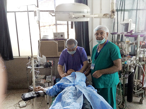 Medical Director of RAHAT PDG Dr R S Parmar (right) operating on a patient.
