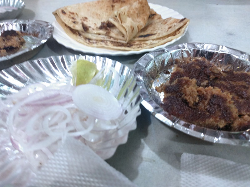 Galouti kebab served with roti and onion.