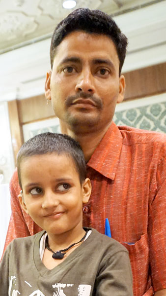 Little Sandesh is all ears, sitting on his father’s lap, post the cochlear implant.