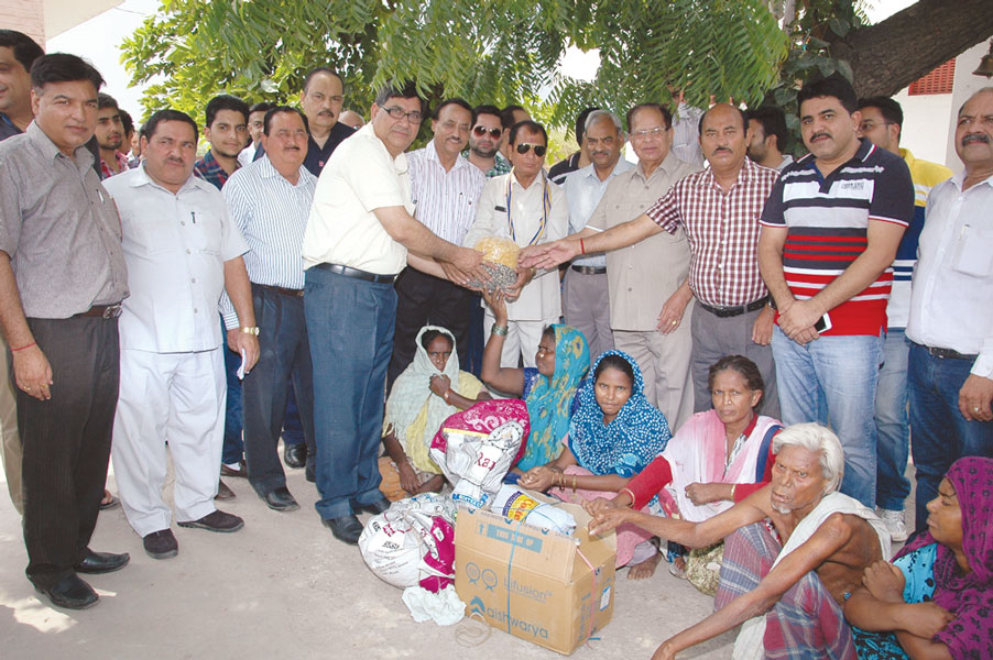 RC Rajpura RI District 3090 Grocery items and medicines distributed to residents of Lepers Colony.