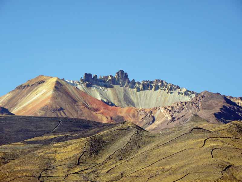 A baby volcano comes alive against a palette of mineral sub-strata.