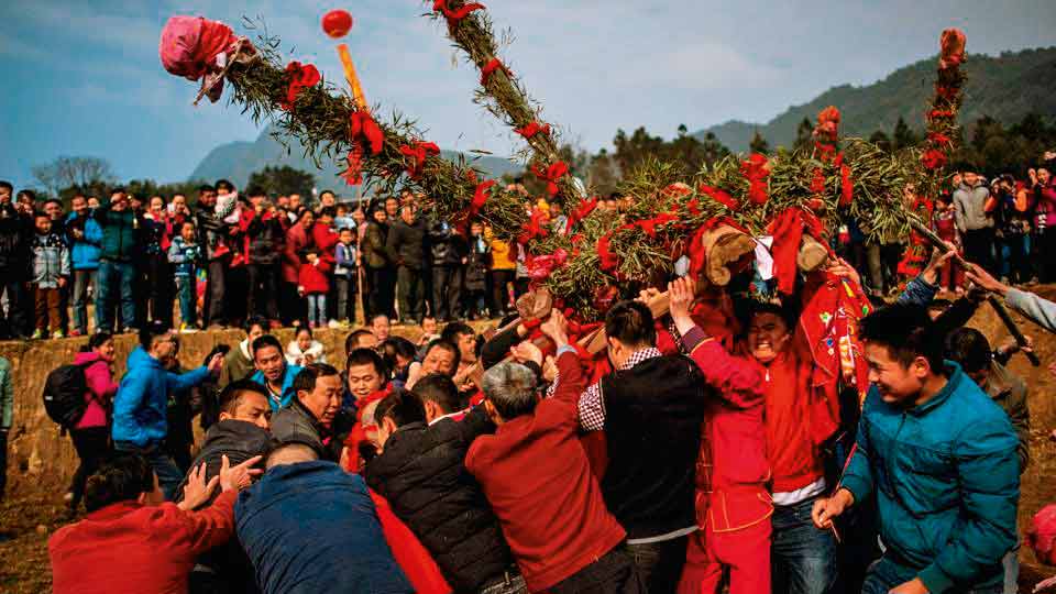 Beating the Buddha for good harvest In a unique ceremony leading up to the traditional Lantern Festival in February, Chinese villagers beat a rock-statue of the Buddha wishing for a good New Year and abundant harvest. The idol is wrapped in a red cloth and tied to a wooden palanquin. Four men attempt to carry it across a river, while another team tries to block them with freshly-hewn bamboo sticks. After a mock struggle, the defenders relent and the Buddha is welcomed into the village with fanfare. This tradition follows a legend where a village suffered heavy floods which ruined the harvest. One of the villagers dreamt of a Buddha idol buried in the fields that could stop the flooding. When they found it, the Buddha wanted to run away and people believed that beating the statue made Buddha stay on.