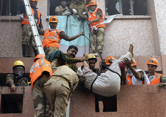 Firefighters rescue a man from a fire accident at the AMRI Hospital, Kolkata.