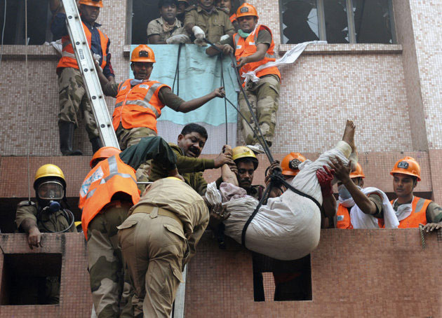 Firefighters rescue a man from a fire accident at the AMRI Hospital, Kolkata.