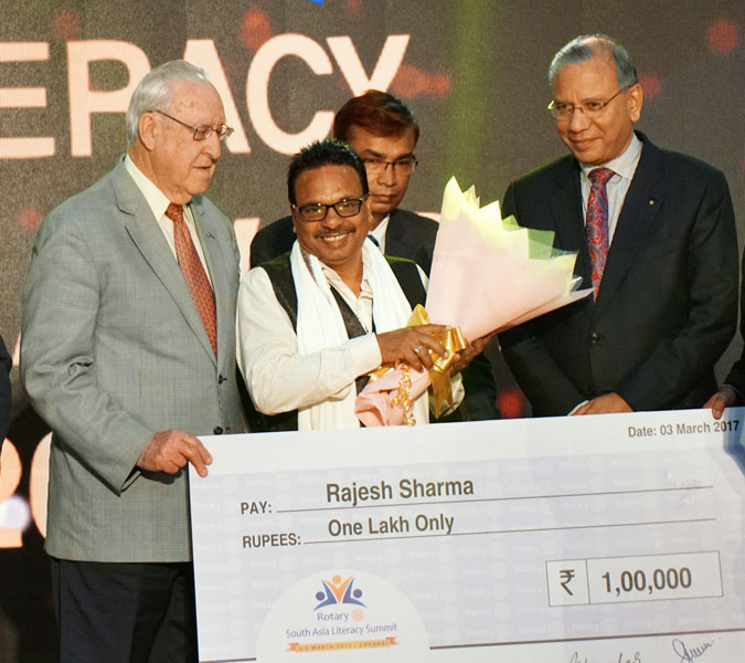 Rajesh Sharma receives the award from RI President John Germ in the presence of IPRIP K R Ravindran.