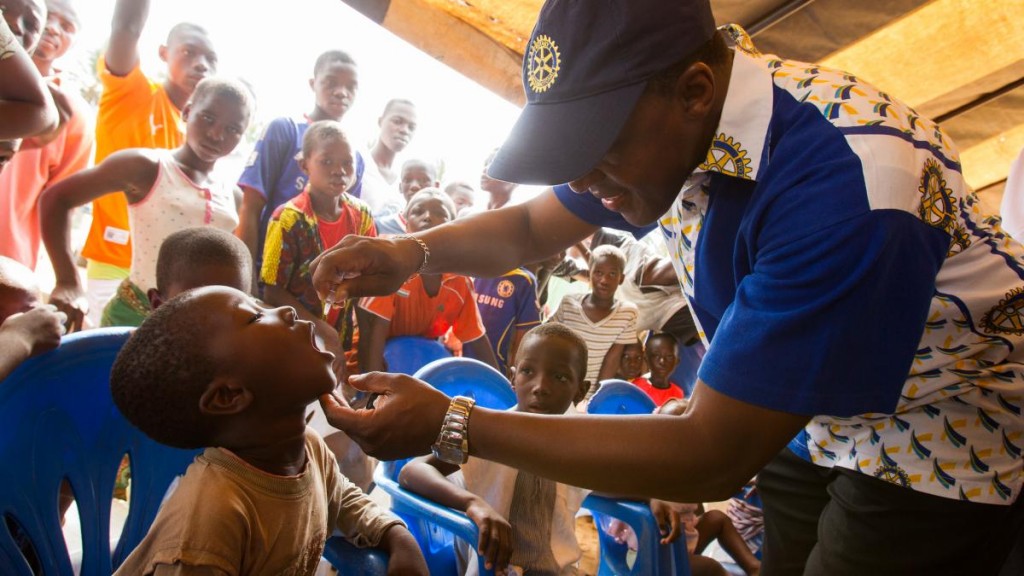 A Rotarian inoculates a child with polio vaccine during a welcome ceremony kicking off a National Immunisation Day (NID) in the village of Messikro, Cote d'Ivoire.