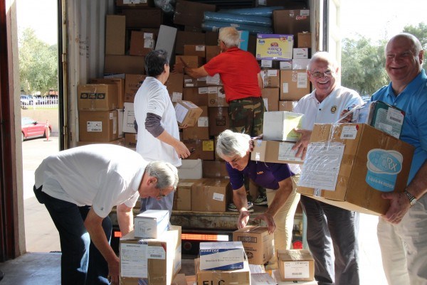 Rotarians from the Scottsdale Sunrise Rotary Club help load up a shipping container with medical supplies headed for Rwanda, Africa.