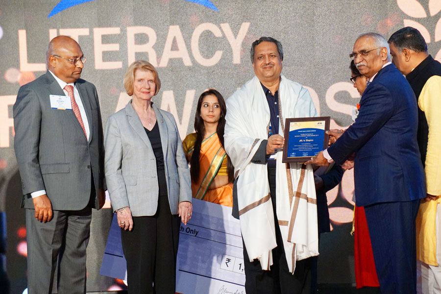 RSALS Chair J B Kamdar hands over the Literacy Hero Award to Aspire's Secretary Dayaram in the presence of Judy Germ and RIDE C Basker.