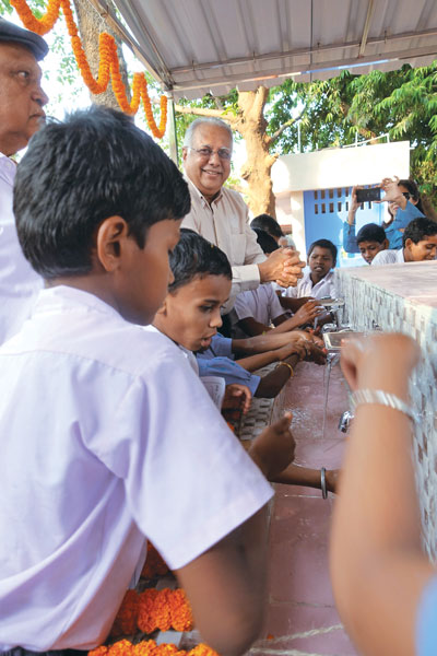 RI Director Manoj Desai inaugurates a group handwashing station.
