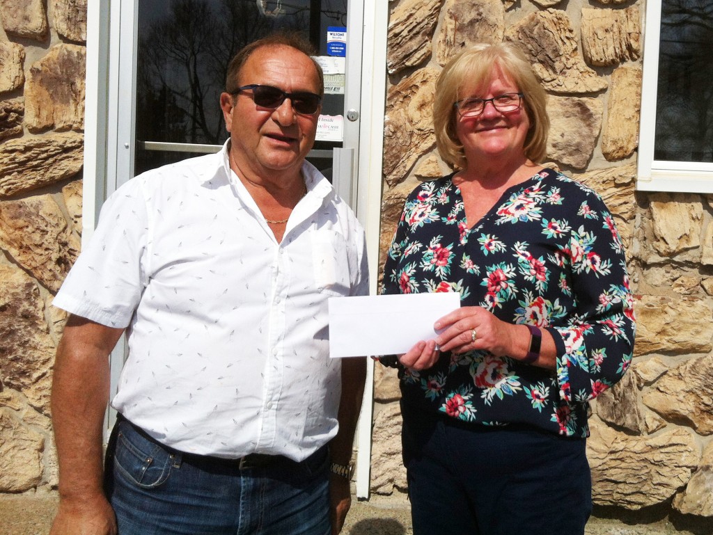Andre Cougias from Acropole presented Wendy Bourque with a $50,000 donation for the splash park the Westville Rotary is building.