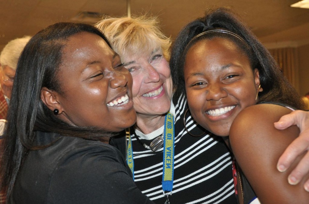 Twin sisters Q'Ladrin Qouters (left) and Q'May Qouters share a hug with Betty Ryberg during the Rotary Club of Aiken meeting at Newberry Hall. Each of the siblings received a $5,000 scholarship from the Rotary club. Ryberg is the chair of the Rotary Club's Scholarship Committee. Photo: Dede Biles