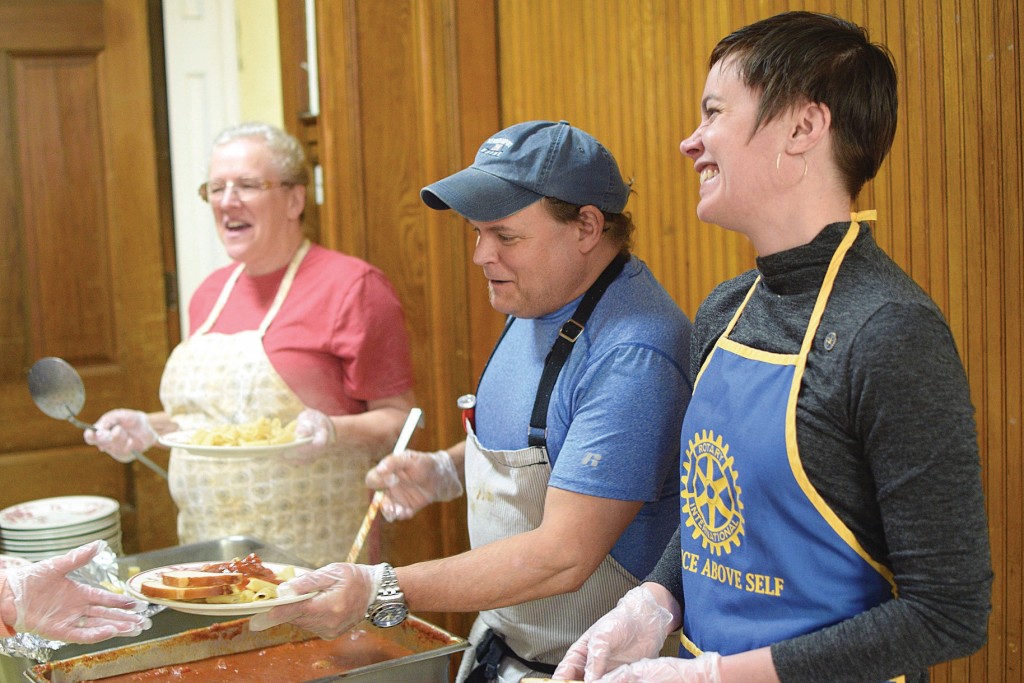 Kitchen Manager Bob Moses and Rotary Club member Emily Watts handed out lunches at the Berkshire Food Project on Tuesday. The nonprofit serves about 100 free lunches every weekday.