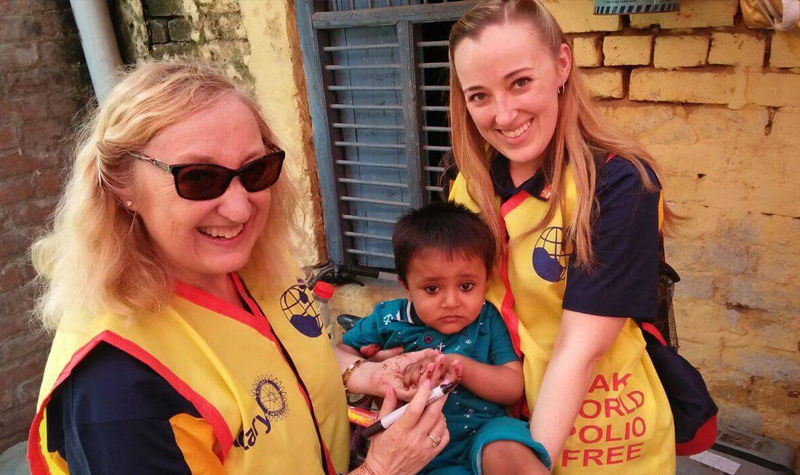 Dianna and Danelle Wilson hold one of the many children that received oral polio vaccine during their trip to India.