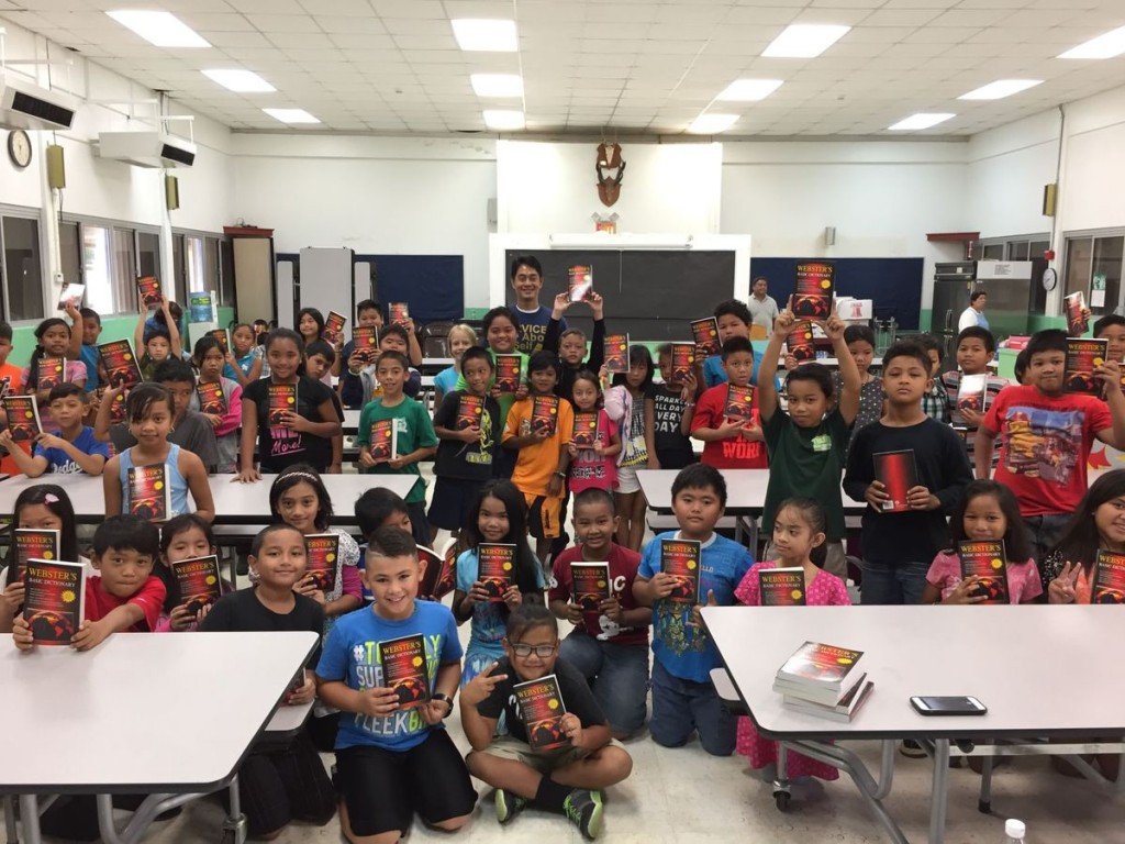 Students at Gregorio T Camacho Elementary School show the dictionaries they received from the Rotary Club of Saipan after the distribution with club vocational services director Wendell M Posadas.