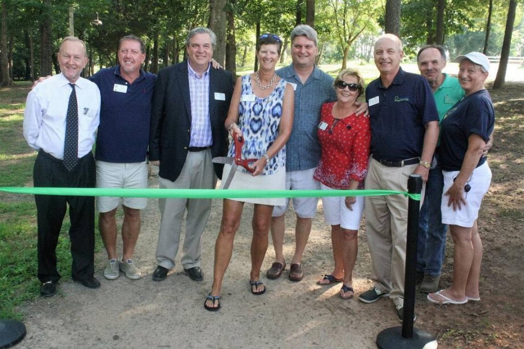 Fort Mill Rotary Club member Susan Fuller cuts the ribbon to officially open Rotary Way at the Anne Springs Close Greenway on June 31. Photo: Andrew Stark