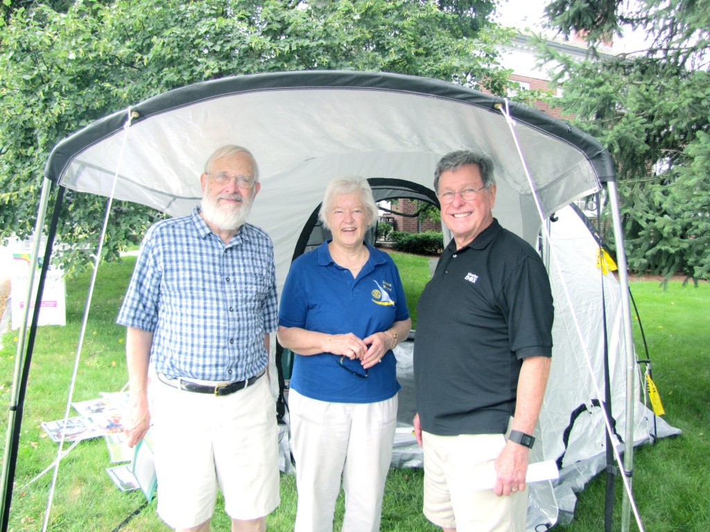 Arthur Walker chats with Ingrid and Doug Detweiler at a ShelterBox display in Concord Centre.