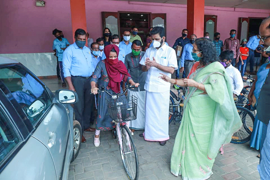 A student gets a bicycle under the district's ‘Pedal to School’ programme.