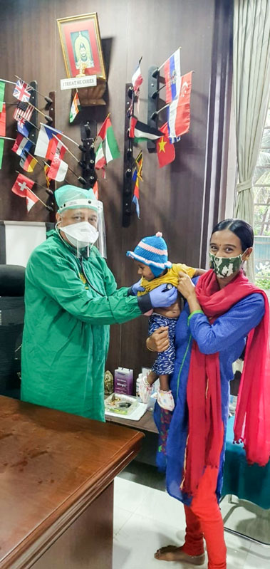 Dr Ranjan Deshpande examining a child in his clinic.