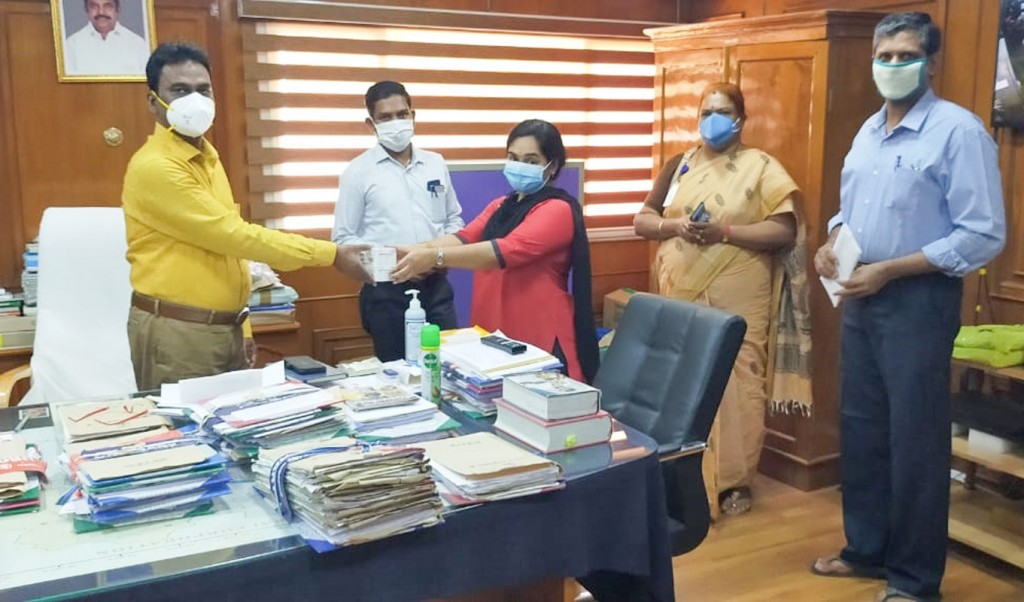 Interact Club of Lakshmi School coordinator Padmaja Rishi donating Covid-relief material to the Madurai corporation commissioner S Visakan.