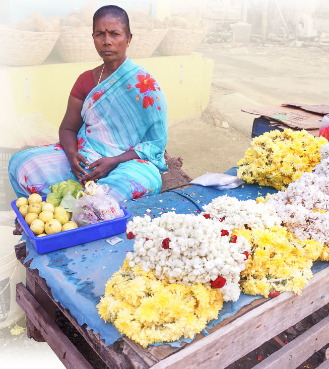 Susheela waits for customers at her roadside flower shop.