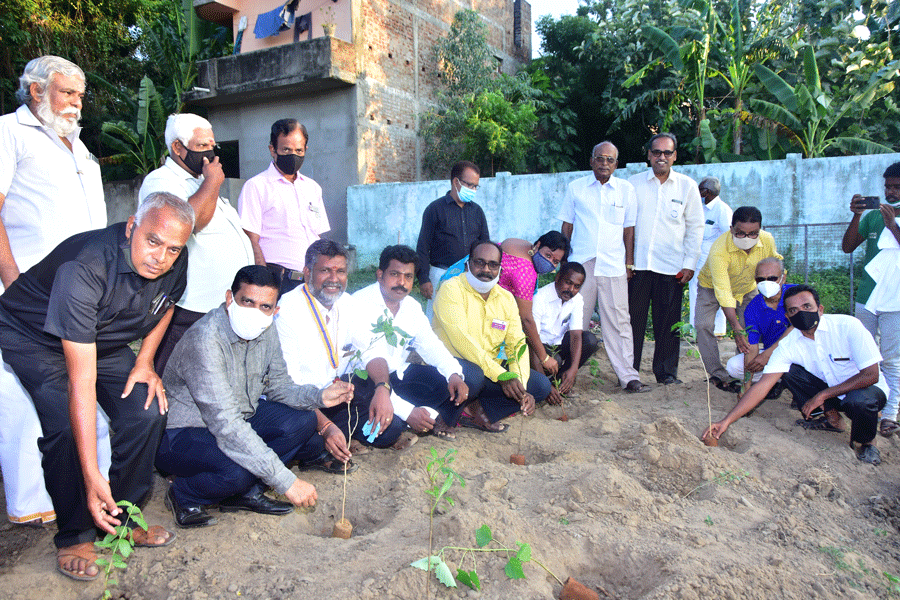 DG Balaji Babu, (second from L, seated) along with members of RC Thiruvarur Kings, planting saplings at a site.
