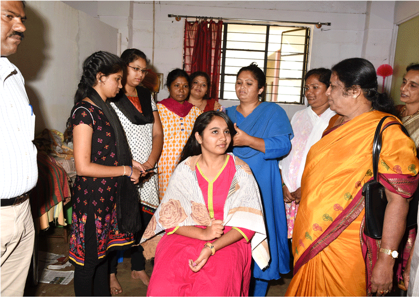 Women learn hairstyling as part of the beautician course.