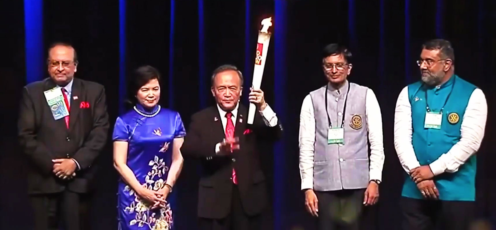RI President Gary Huang holds aloft the Polio Flame at the Sao Paulo Convention in 2015. From L: PRID P T Prabhakar, RC Madras president S N Srikanth and secretary N K Gopinath.
