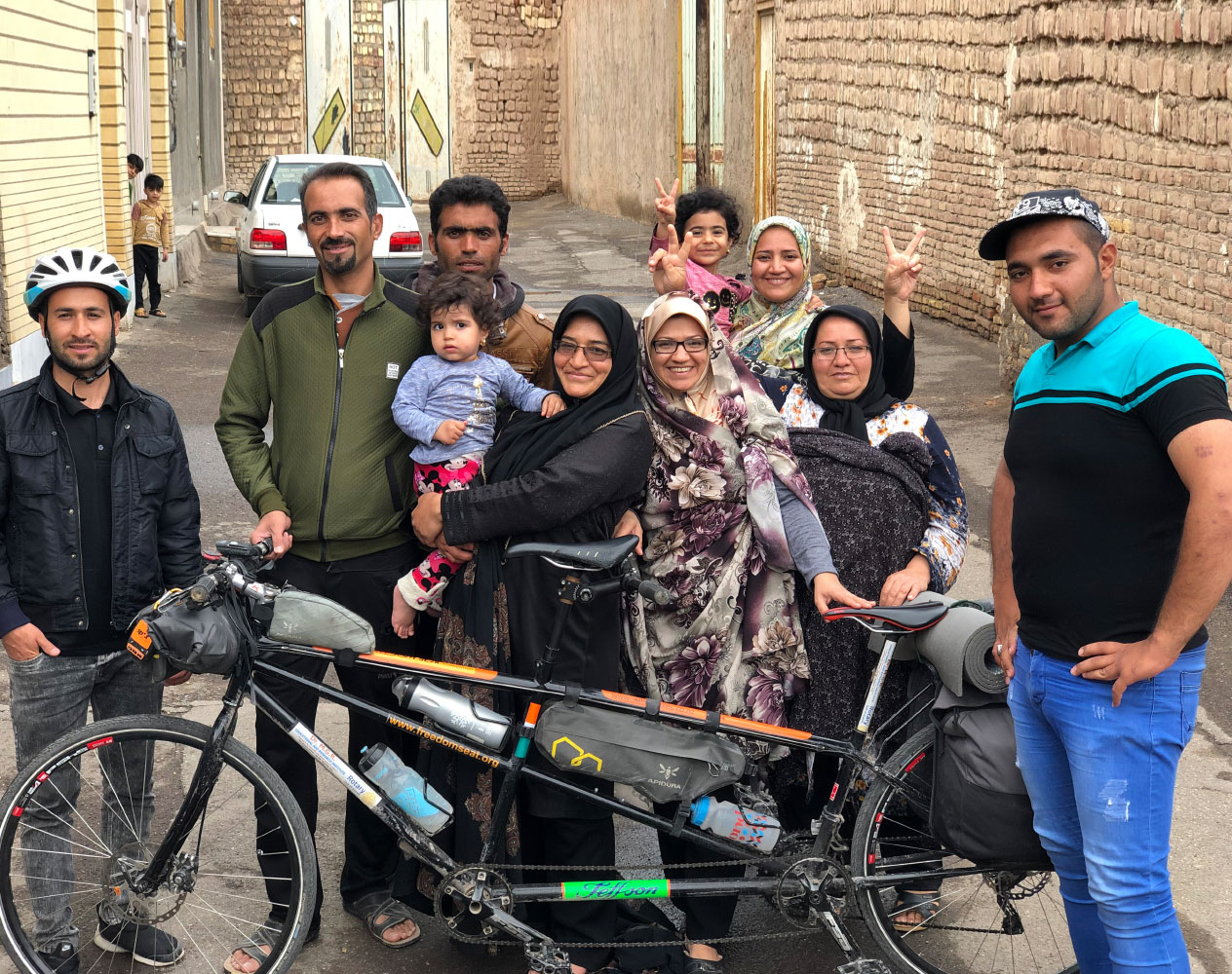The Iranian family who hosted Naresh Kumar pose with his Tandem cycle. 