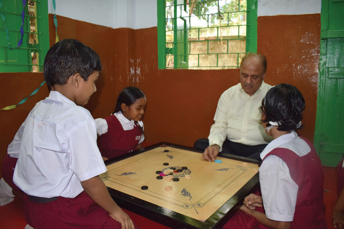  Playing carrom with students at the Paresh Nath Vidyalaya school in Kolkata.