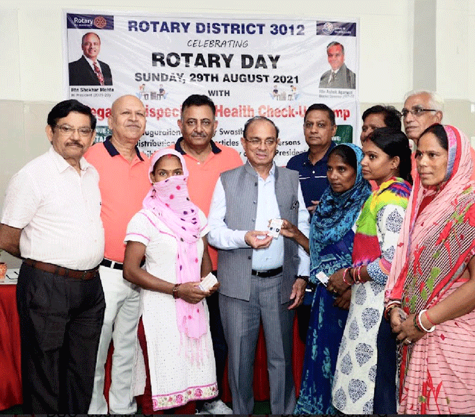 PDG J K Gaur (centre) distributing health cards ­introduced by RC Sonipat Midtown for ­underprivileged women.