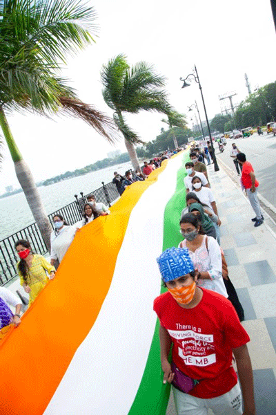 Volunteers carrying a 150m national flag as part of the rally.