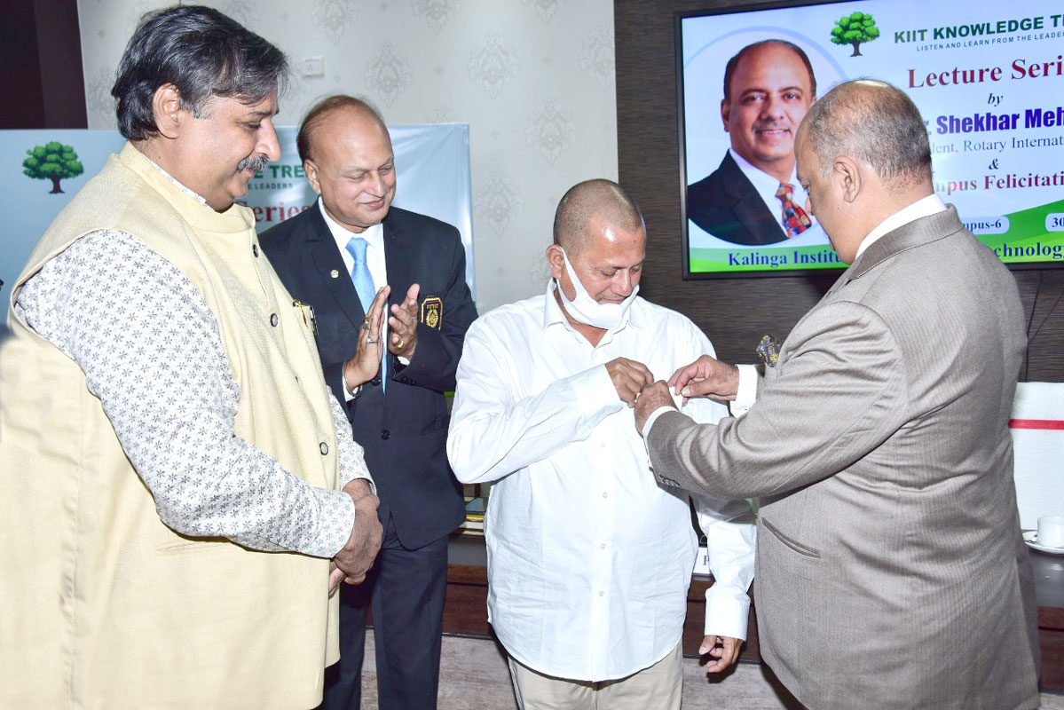 RI President Shekhar Mehta honours Achyuta Samanta, founder, Kalinga Institute of Industrial Technology, and Social Sciences, with a Rotary pin in the presence of DG Santanu Kumar Pani (third from R).