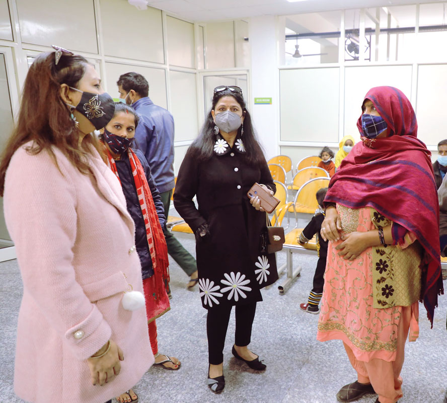 Aruna (centre), wife of DG Ashok Aggarwal, and club members interacting with outpatients at the hospital.