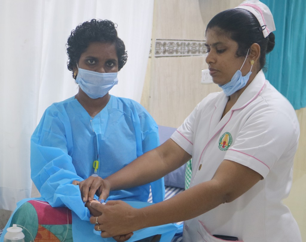 Shobana waiting at the palliative care unit with nurse Ramuthai.