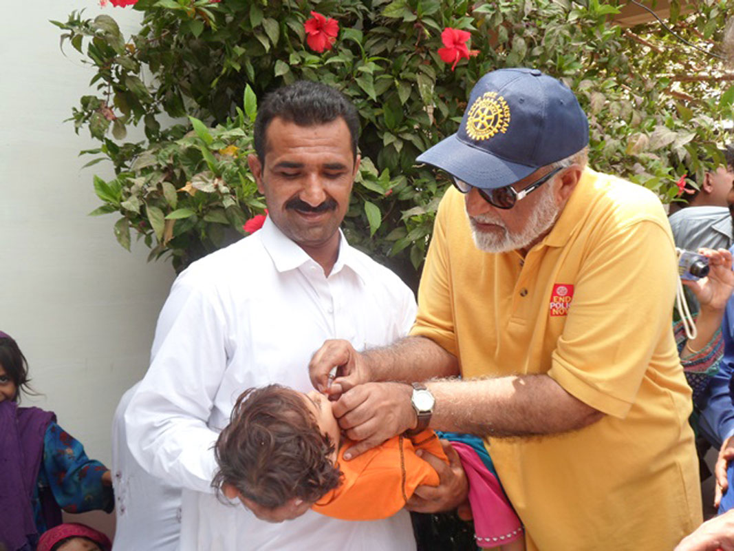 Sindh zonal polio coordinator Masood Bhali (R) at the Jamali Goth health camp.