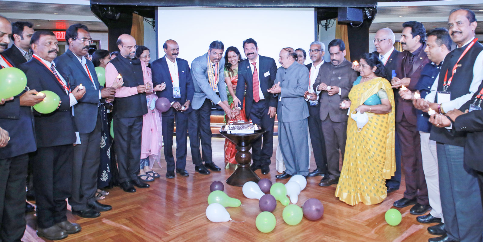 DG K Srinivasan, Beena and DGE Babumon cut the Rotary anniversary cake aboard the ship in the presence of the past district governors. 