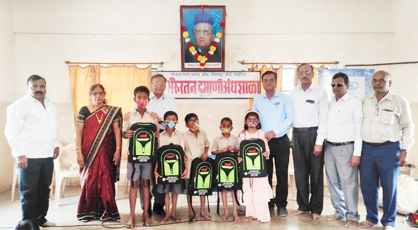 School bags given to children at the reopening of the school in the presence of (from L) club’s past president Dr Siddheshwar Wale, Lalita Somani, Prakash Somani, club president Dr Degaonkar, school secretary Bhandari, headmaster Darshanale and project coordinator Vibhishan Kadam.