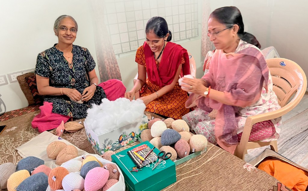 Members of the Saaisha India Foundation making the knitted knockers. 