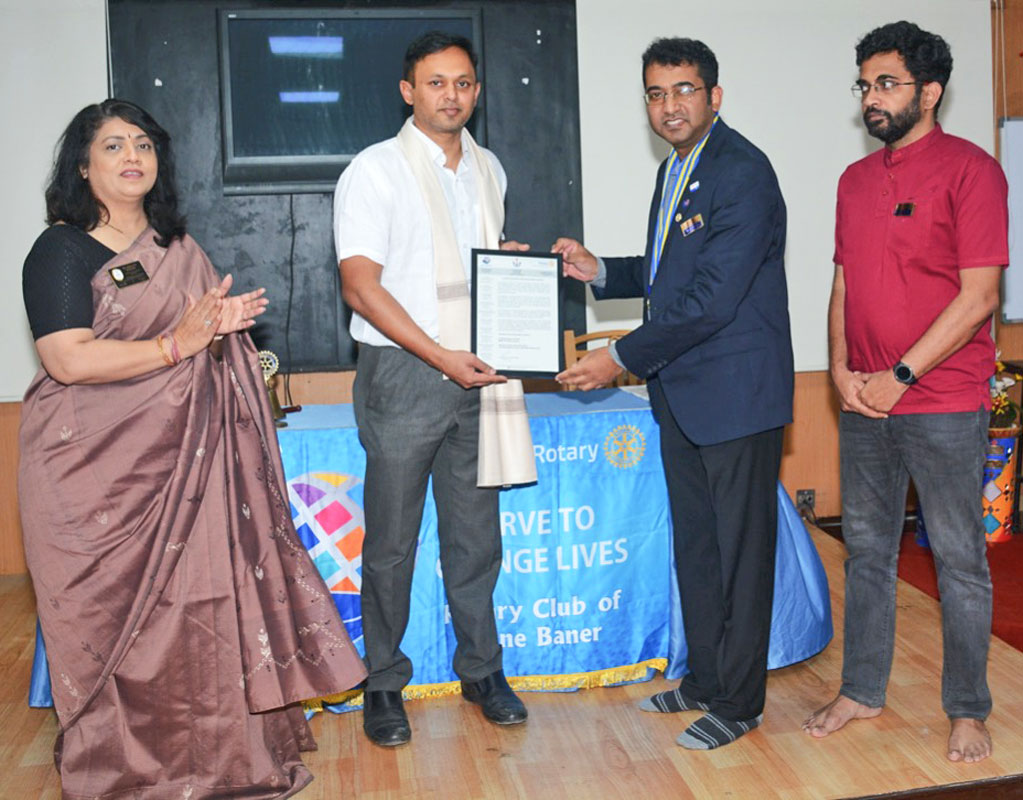 Neurosurgeon Dr Nilesh Kurwale receives the Vocational Excellence Award from club president Saraf in the presence of DGN Manjoo Phadke and Rtn Aniruddha Joshi.