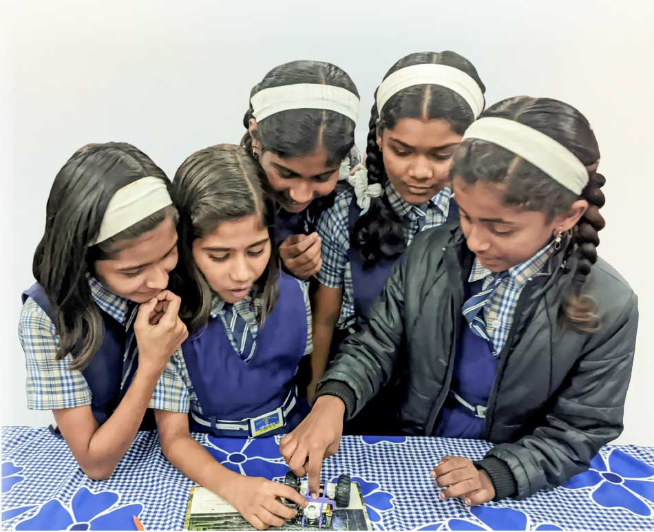 Students working on a robot at the Lonikand Zilla Parishad School near Pune.