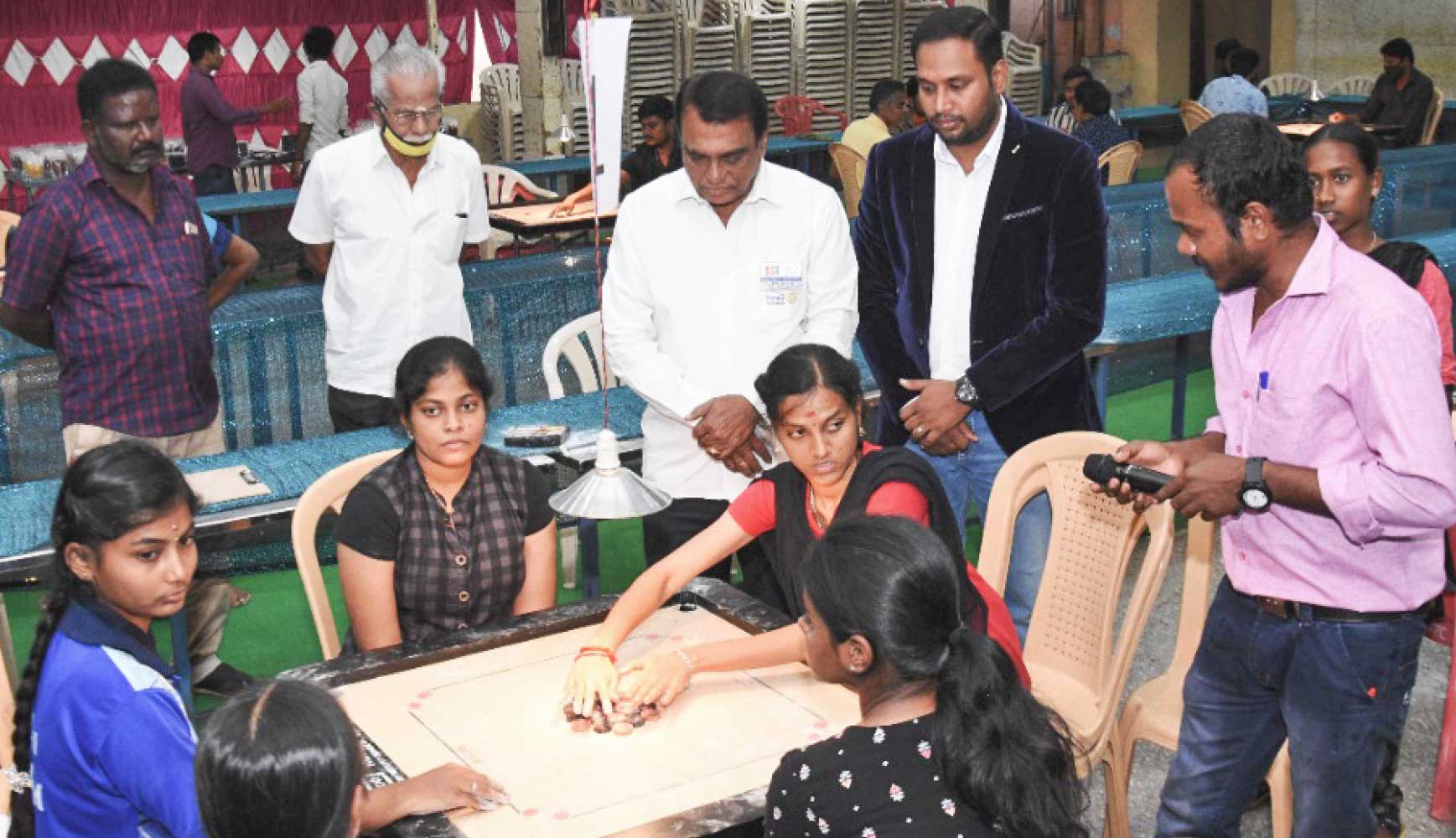 A state-level carrom tournament in progress. Past president Sabarish (2nd from R) looks on.
