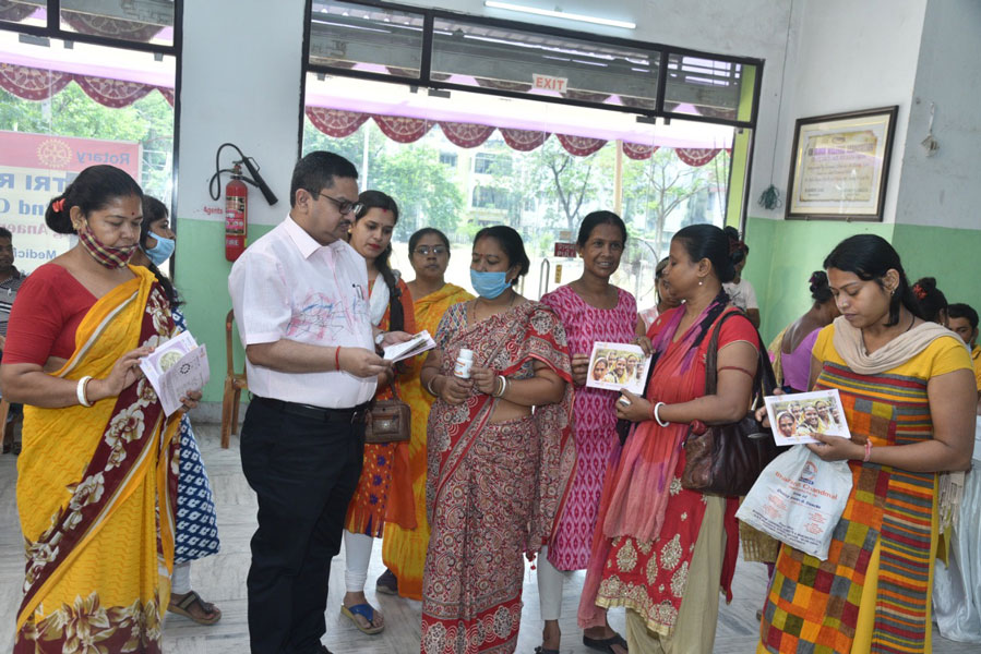 Booklets on anaemia being distributed to women at the camp.